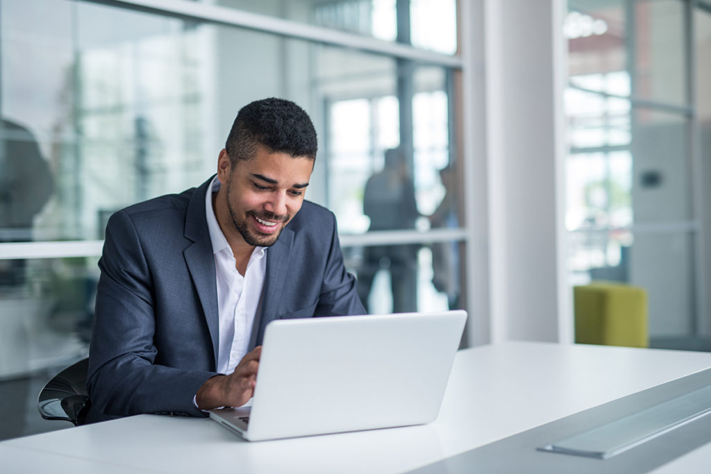 African american businessman working on a laptop.